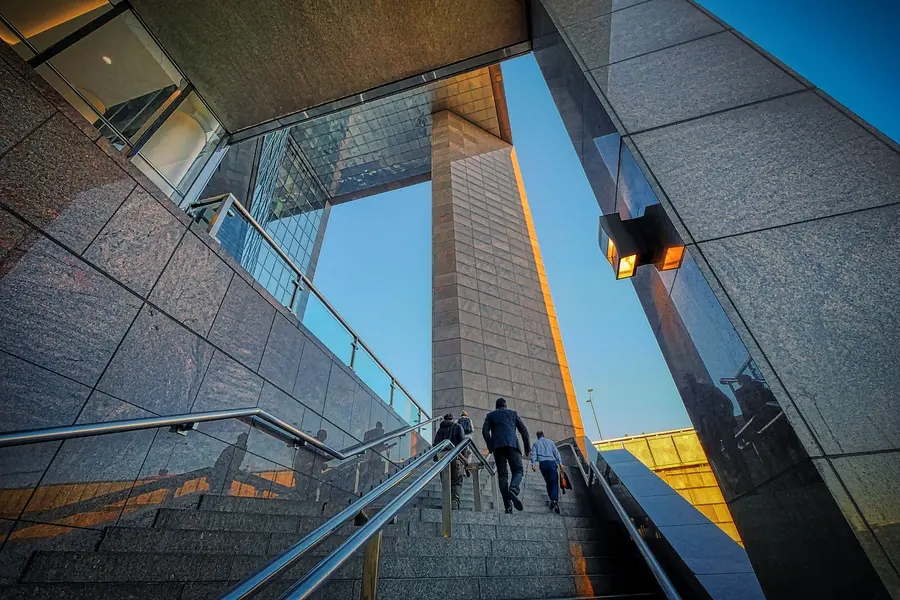Professional business people walking upstairs on a city building